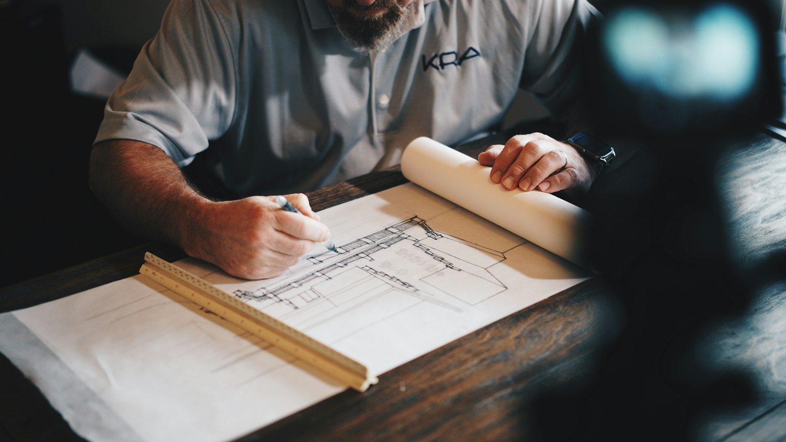Architect drawing a diagram at a desk